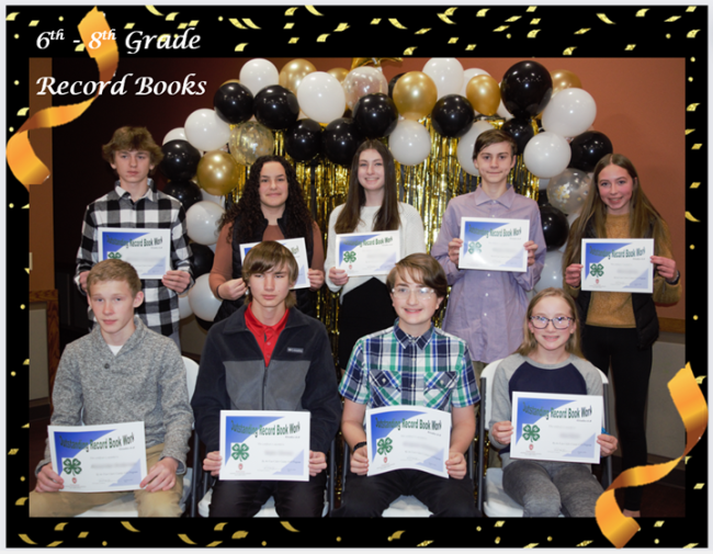 Group picture of 4-H Youth with certificates of achievement.