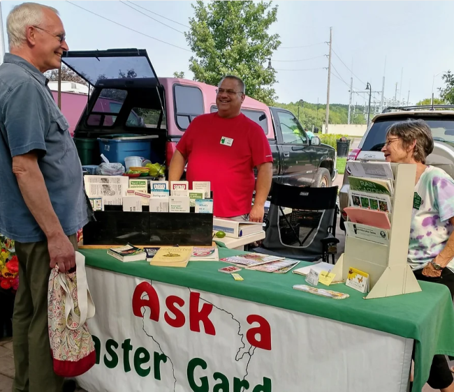 Master Gardeners at the "Ask a Master Gardener" booth at the Farmers Market.